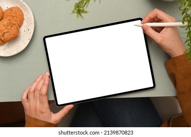 Top view, A female designer designing her graphic image on digital graphic tablet touchpad on her modern office desk. Tablet white screen mockup - Powered by Shutterstock