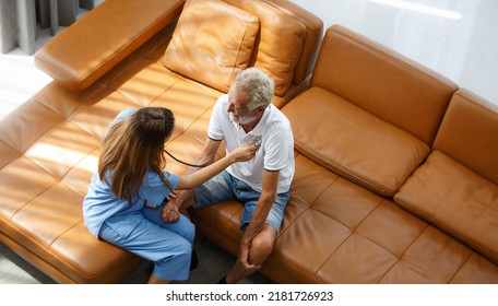 Top View Female Doctor Sitting On Sofa In Exam Room Clinic Holding A Stethoscope For The Breath Of An Elderly Male Patient Heart Or Lung Examination Professional Wearing A Medical Gown And Stethoscope