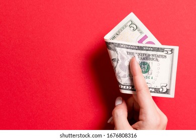 Top View Of Female Hand Holding A Pack Of Money On Colorful Background. Five Dollars. Business Concept With Empty Space For Your Design. Charity And Tips Concept.