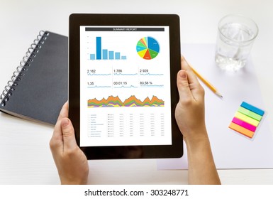 Top View Of Female Hand Keep Digital Tablet With Analytical Data By Summary Report