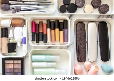 Top View Of Female Visagiste Is Neatly Placing Cosmetic And Vanity Items In MUJI's PP Makeup Storage Boxes With Various Sizes On White Marble Dressing Table. Decluttering And Organization Concept.