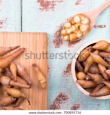 Top view of Fingerroot on wooden background in square format