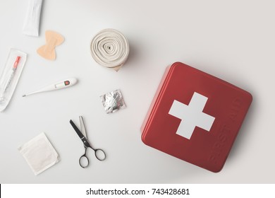 Top view first-aid kit with medical supplies isolated on white