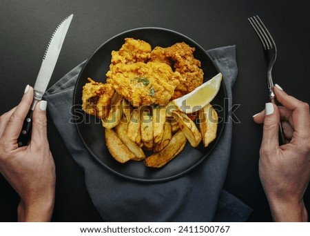 top view fish chips plate with woman holding cutlery