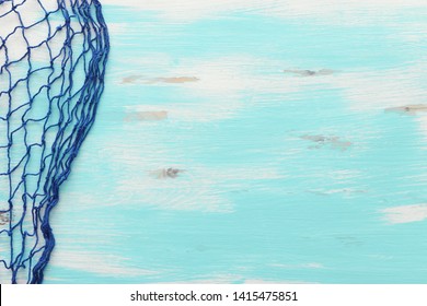 Top view of Fishnet on pastel blue wooden background. top view, flat lay