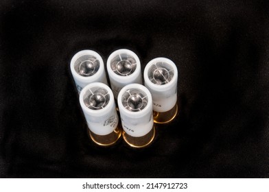 top view of five shotgun shells, white body and clear plastic front , 