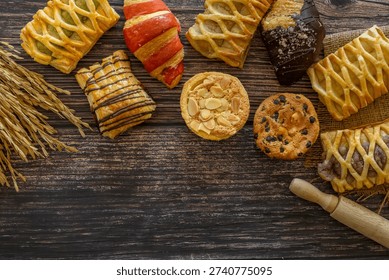 Top view flat lay of Assorted fresh bakery pastries and cookies arranged on a rustic wooden table