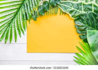 top view flat lay background with tropical leaves with copy space
