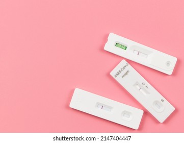 Top View Or Flat Lay Of Covid-19 Three Negative Test Result Antigen Test Kits (ATK)  On Pink  Background With Copy Space. Antigen Test Kits For Self Collect Nose Swab.