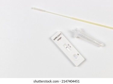 Top View Or Flat Lay Of Covid-19 Negative Test Result Antigen Test Kit (ATK)  With A Nasal Swab On White  Background With Copy Space. Antigen Test Kit For Self Collect Nose Swab.