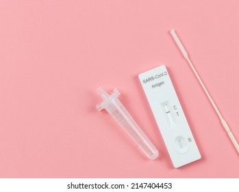 Top View Or Flat Lay Of Covid-19 Negative Test Result Antigen Test Kit (ATK)  With A Nasal Swab On Pink Background With Copy Space. Antigen Test Kit For Self Collect Nose Swab. 