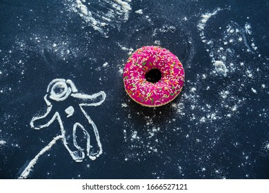 top view flat lay creative still life with pink donut and spaceman made from flour on a black background 