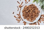 top view flat lay dry dandelion root in white bowl on table food background copy space. 