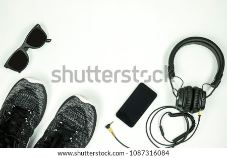 Top view, Flat lay of excercise concept, running shoe with mobile phone, earphone and accessories on white background with copy space.