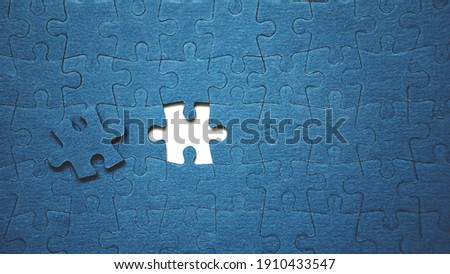 Top view flat lay of jigsaw puzzle with one piece missing .Concept of absence and incomplete.Putting the last piece finding solution