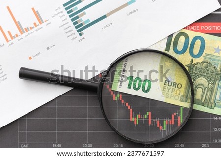 top view and flat lay the magnifying glass on business graphs, graph charts on the table .business office company meeting concept Foto stock © 