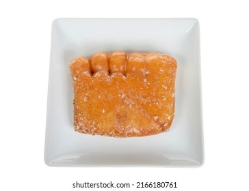 Top View Flat Lay Of One Bear Claw Donut On A Fancy Off White Square Porcelain Plate, Isolated On White. A Yeast Donut Shaped Like A Bear Claw. Filled With Apple Fruit And Covered In Sugar Glaze.