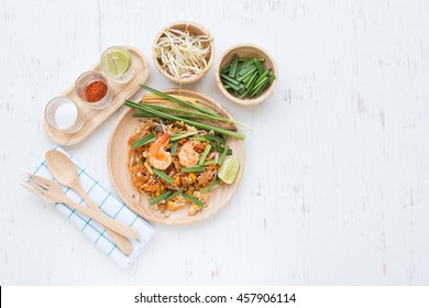 Top View, Flat Lay Of Pad Thai With Garnish On White Rustic Wooden Table, Thai Food 