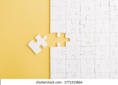 Top View Flat Lay Of Paper Plain White Jigsaw Puzzle Game Texture Last Pieces For Solve And Place, Studio Shot On A Yellow Background, Quiz Calculation Concept