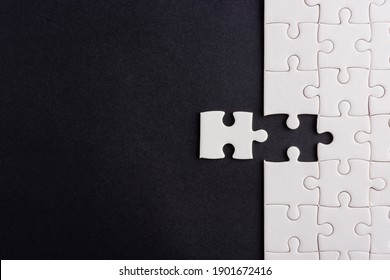 Top View Flat Lay Of Paper Plain White Jigsaw Puzzle Game Texture Last Pieces For Solve And Place, Studio Shot On A Black Background, Quiz Calculation Concept