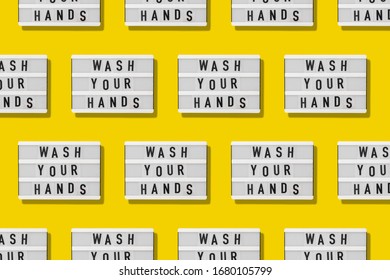 Top view flat lay pattern yellow background. Lightbox with wash your hands text. Covid-19 pandemic