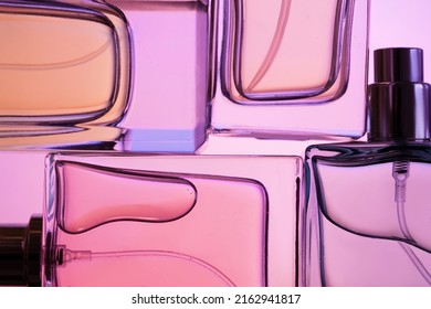 Top view, flat lay of a set of perfume bottles on a purple background. - Shutterstock ID 2162941817