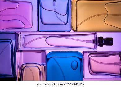 Top view, flat lay of a set of perfume bottles on a purple background. - Shutterstock ID 2162941819