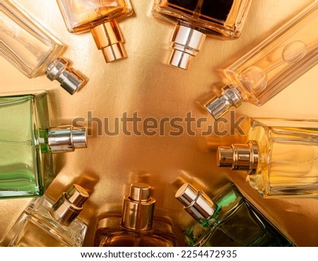 Top view, flat lay of a set of perfume bottles on a on a colorful background