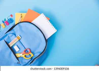 Top View Flat Lay Of Student Blue Bag Backpack Have Stationery Equipment Inside For Education Children Isolated On Blue Background And Copy Space, Back To School Concept