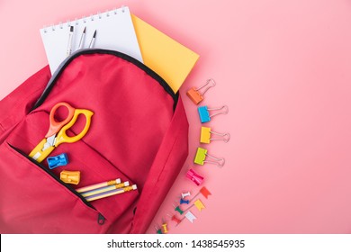 Top View Flat Lay Of Student Red Bag Backpack Have Stationery Equipment Inside For Education Children Isolated On Pink Background And Copy Space, Back To School Concept