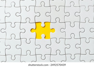 Top view flat lay of white jigsaw puzzle game texture incomplete or missing piece on a yellow background. - Powered by Shutterstock