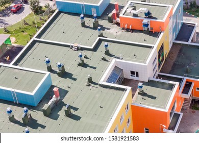 Top view flat roof with air conditioners and hydro insulation membranes on top of a modern apartment.