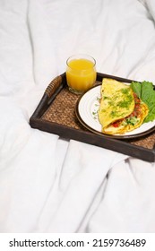 Top View Of A Flatley Breakfast Tray With Scrambled Eggs And Greens And A Glass Of Orange Juice In A Stylish White Bed No People. Concept: Healthy Breakfast Calories Diet Food 