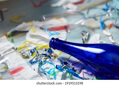 Top View Of Floor With After A Party Celebration With Empty Blue Bottles, Wine Glass And Party Decorations, Messy Living Room Interior, After Party Chaos, Birthday