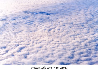 Top view of fluffy cloud sky view from flying airplane window