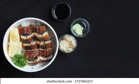 Top View And Focus To Unadon Or Unagi Donburi Or Eel Bowl Is A Dish Originating In Japan On Black Background.