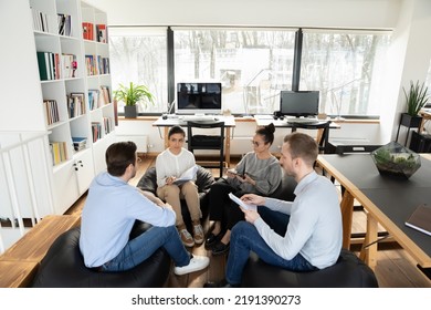 Top View Focused Young Motivated Multiracial Diverse Business People Sitting On Frameless Bean Bag Style Chairs In Modern Office Involved In Teambuilding Activity, Training Or Educational Seminar.