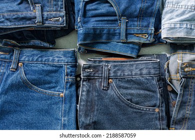 top view folded jeans Blue jeans stack jeans   Top view various denim fabrics white background  Several long jeans