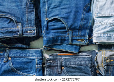 Top view folded jeans Blue jeans stack jeans   Top view various denim fabrics white background  Several long jeans