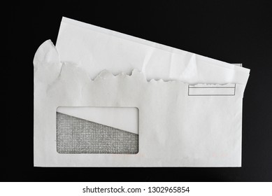 Top View Of Folded Letter In Torn Open Envelope On Black Background