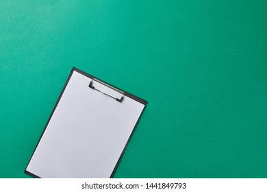 top view of folder with empty paper isolated on green