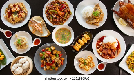 Top view food platter combo set of traditional Cantonese yum-cha Asian gourmet cuisine meal food dish on the white serving plate on the table, includes dishes of duck, pork, fish, chicken, vegetables