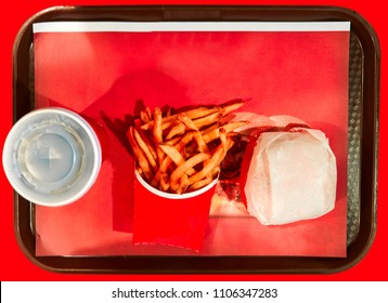 Top view of food tray served with a burger fries and soda combo