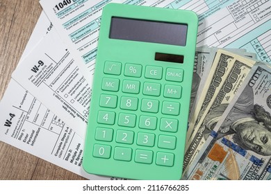 Top View Of The Form 1040 Tax Return, Where The Question Of Payment Of Taxes And Dollars. The Concept Of Forms Of The United States And The Payment Of Taxes