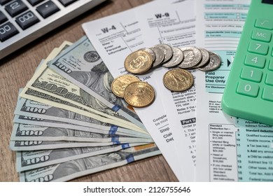 Top View Of The Form 1040 Tax Return, Where The Question Of Payment Of Taxes And Dollars. The Concept Of Forms Of The United States And The Payment Of Taxes