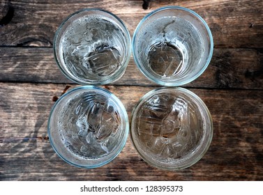 Top View Of Four Glasses Of Water With Ice