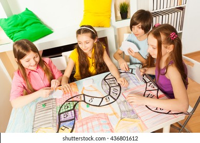 Top view of four kids playing the tabletop game