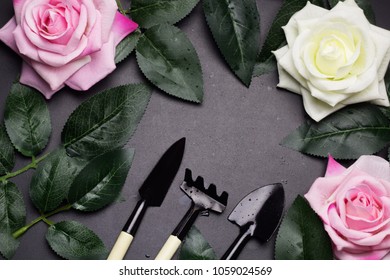 Top View Frame Of Gardening Tools ,rose Leaves, Rose Flowers. Blackbackground Copy Space