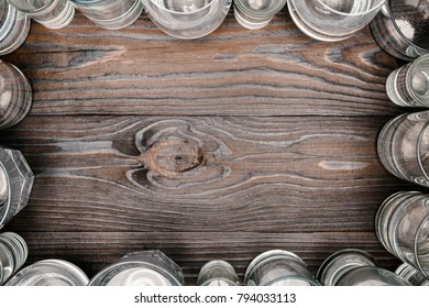 Top View Of Frame With Glasses Of Water On Wooden Table