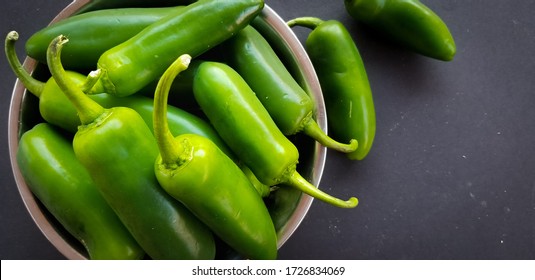 Top View Of Fresh Jalapeño In Aluminum Bowl On Black Background. Closed-Up View.